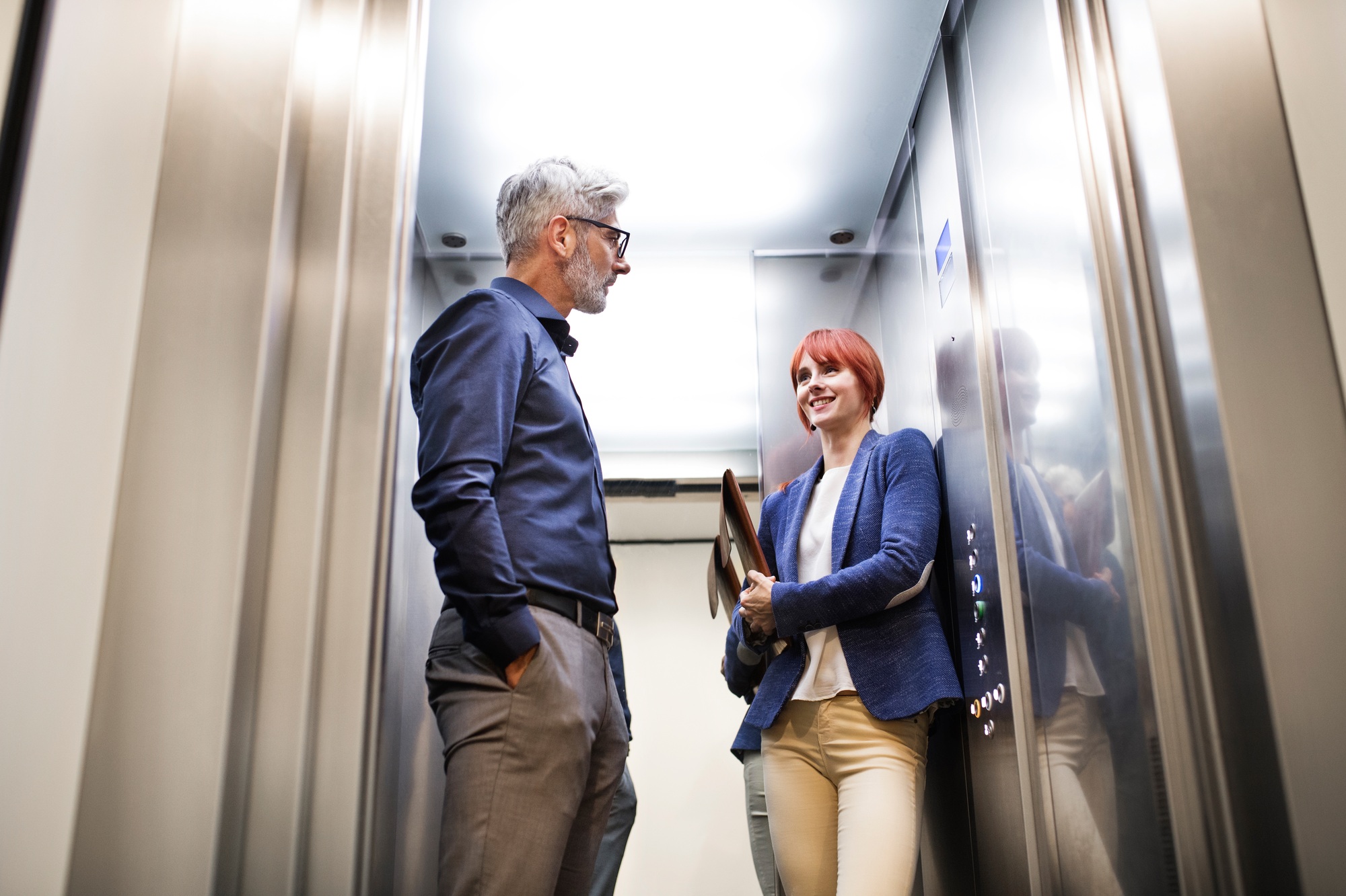 Business people in the elevator in modern office building.
