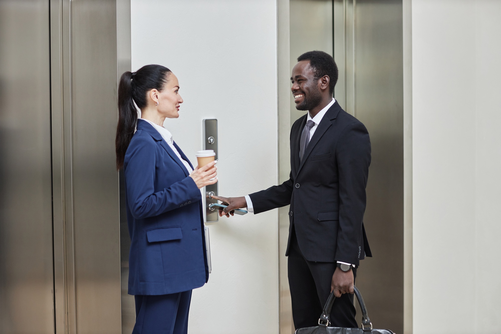 Coworkers Talking by Elevator